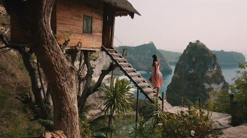 Woman Stairs to Treehouse with Ocean View at Nusa Penida
