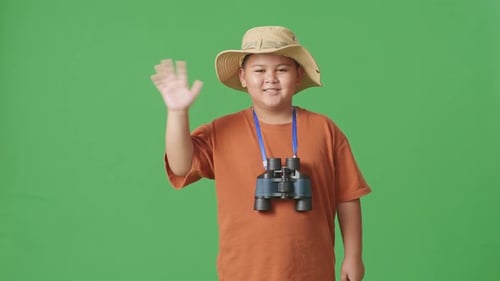 Tourist Boy Researcher Smiling And Waving Hand On The Green Screen Background