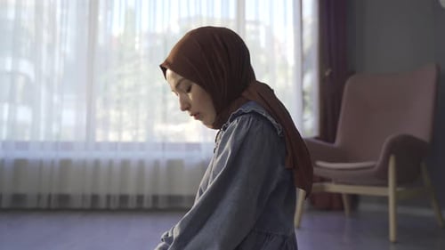 Happy young muslim woman praying in islamic faith.