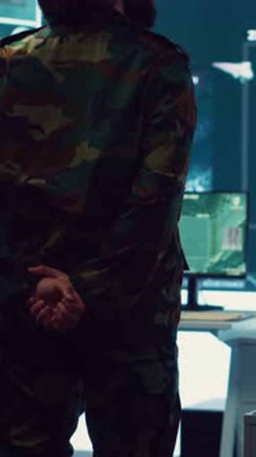 Man in Camouflage Uniform Standing in Control Room