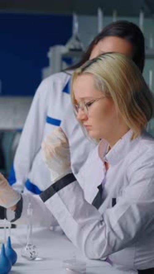 Scientists Working with Test Tubes in a Lab