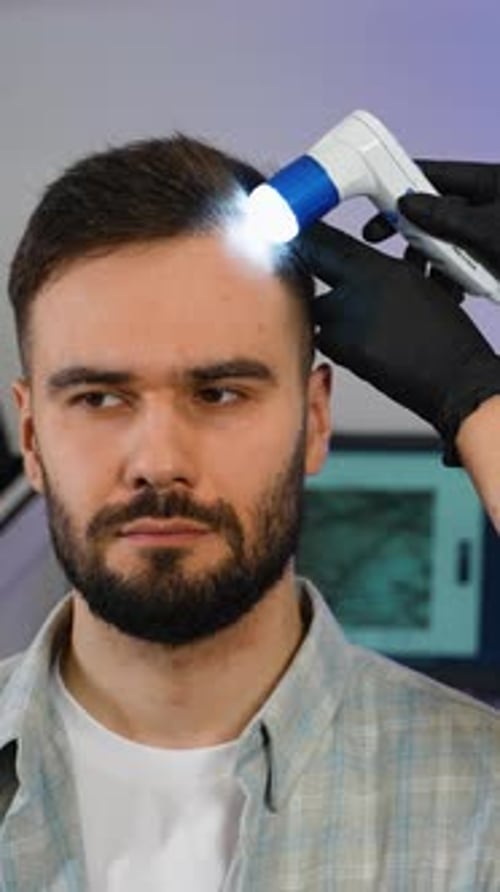 Trichologist Examining Man's Hair and Scalp with Dermatoscope
