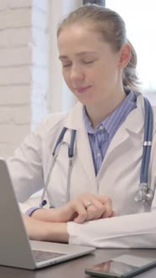 Female Doctor Doing Online Video Consulting in Hospital, vertical video