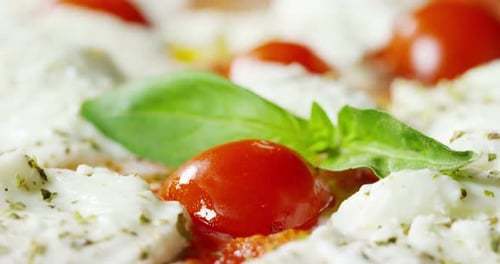 Delicious Pizza Close Up with Tomatoes and Basil