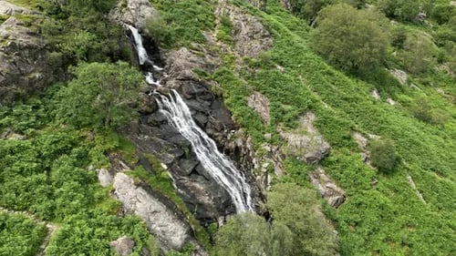 Scenic Waterfall Cascading Down Mountain Slope