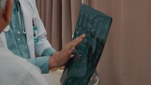 Doctors Discussing X-ray Results in Hospital Room