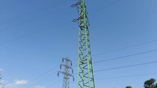 Electric lines on two high pylons transferring electricity