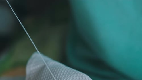 Adult Hands Sewing White Fabric Close Up