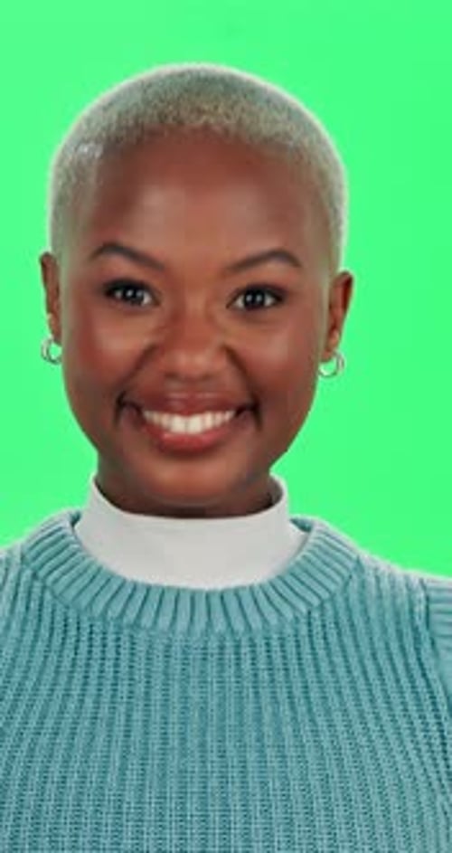 Happy, smile and face of black woman on green screen for positive energy, joy and excited in studio