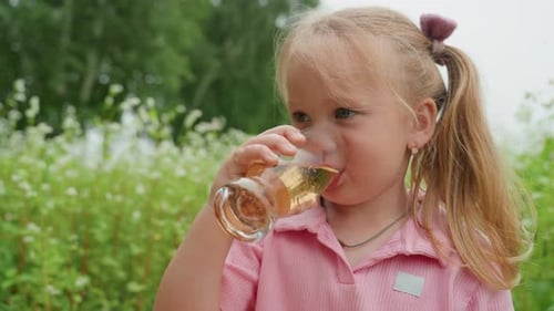 Un niño disfruta de una bebida espumosa al aire libre, una niña se ríe mientras bebe una bebida burbujeante al aire libre