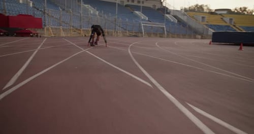 Female Runner at Starting Block Getting Ready Before Run