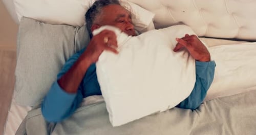 Sleep stress, senior and man with insomnia in bed at home with struggle and bad dream