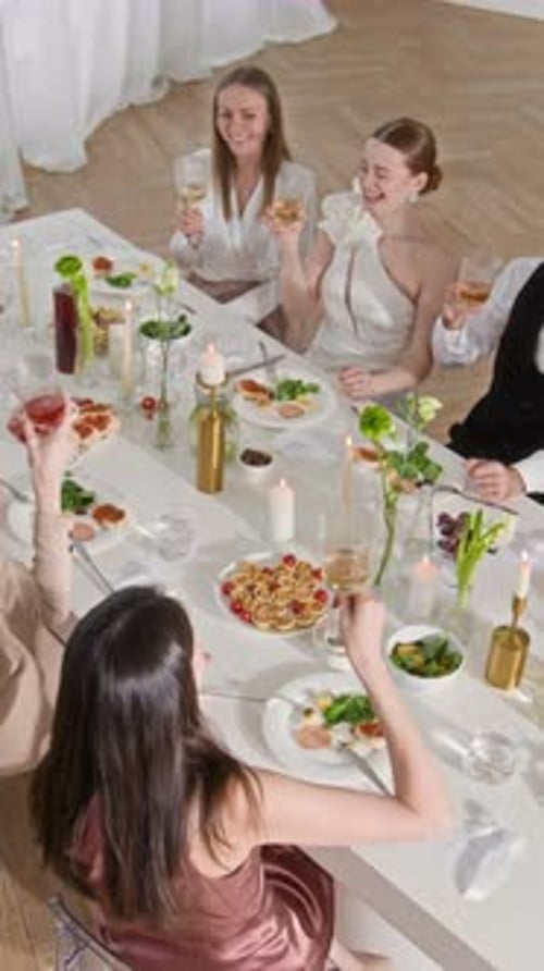 Group Toasting Drinks Together at Elegant Table