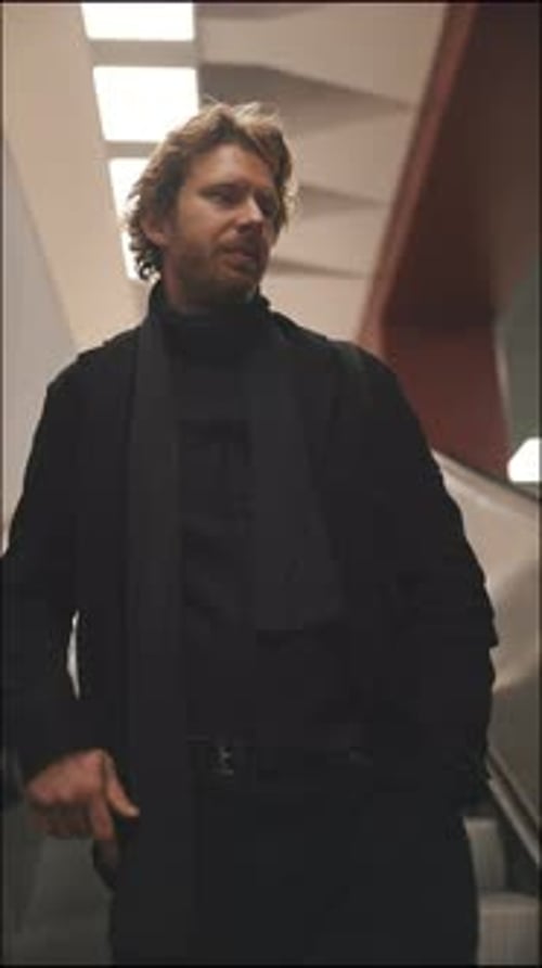 Stylish Man Commuting on an Escalator in a Subway Station