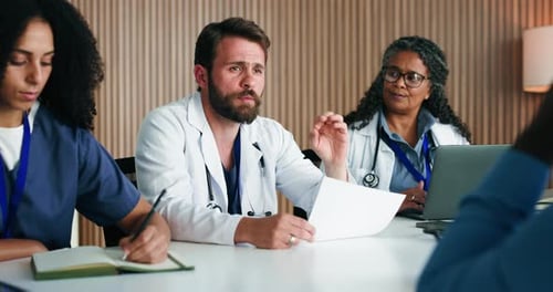 Medical Professionals Talking at a Meeting in Office