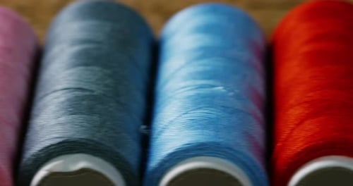 Macro Shot of Colorful Sewing Threads on Spools