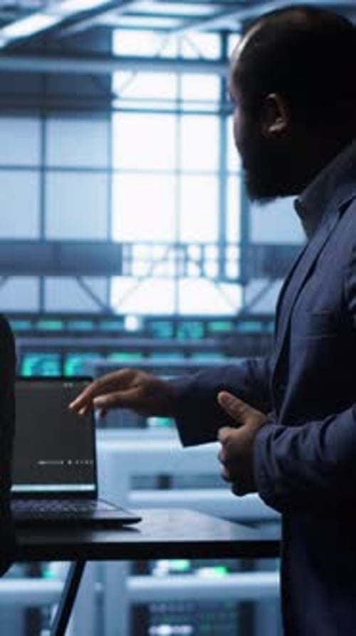 Vertical Video Team of Engineers in Data Center Doing Brainstorming to Fix Problems