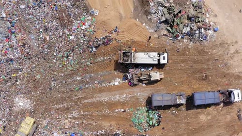 Aerial View of Vast Urban Landfill with Heavy Machinery