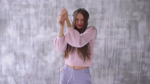 Young Woman Dancing and Listening to Music