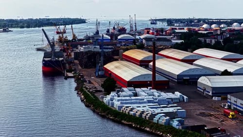 Drone establishing of busy shipping port with cargo containers and ships