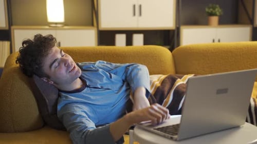 Young Man Video Chatting on Laptop Falls Asleep