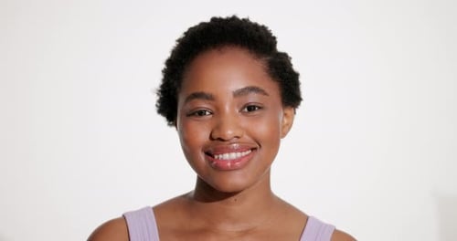 Happy, black woman and face with beauty in studio for skincare, smooth skin and natural makeup