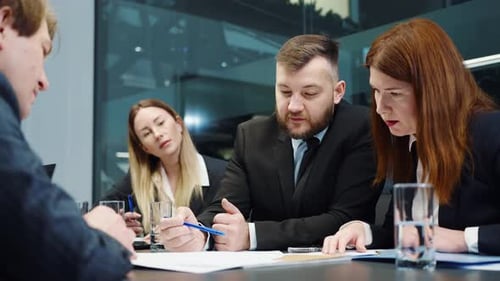 Business Team Collaborating on Project in Modern Office
