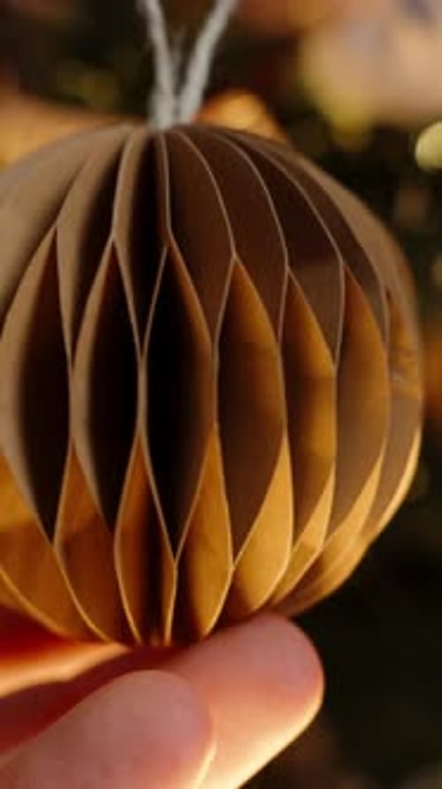 Unique Paper Christmas Ornament Held by Hand