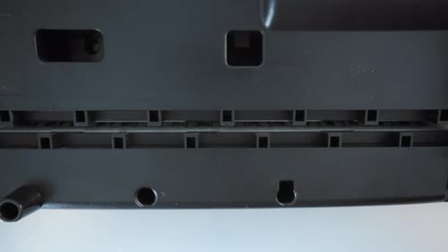 A Close Up View of a Paper Shredder Cutting a Sheet of Office Paper Into Thin Strips