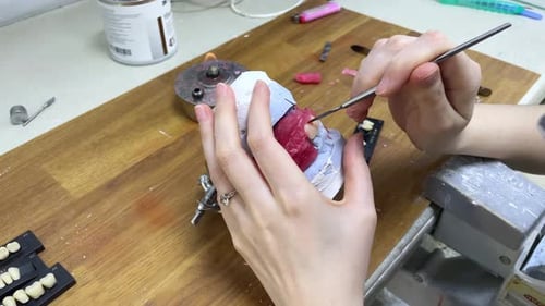 Dentist Sculpting Detailed Dental Mold in Lab