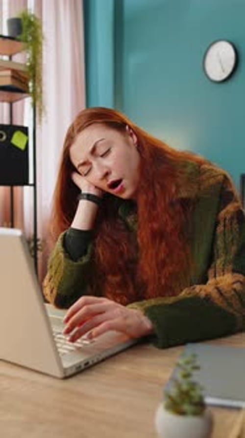 Bored Sleepy Business Woman Worker Working on Laptop Computer Yawns Leaning on Hand at Office Desk