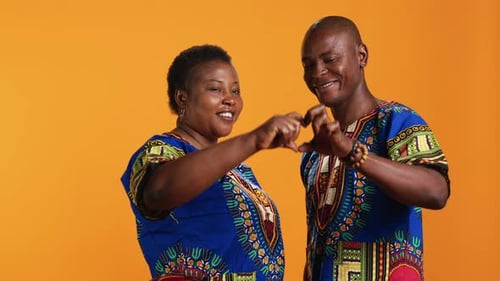 Sweet Romantic Couple Presenting Heart Shape Sign