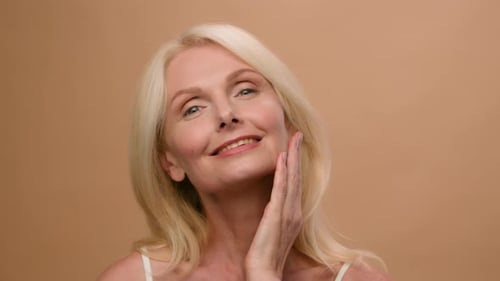 Close Up Portrait in Studio Beautiful Mature Old Woman Caucasian Model Touching Soft Moisturized