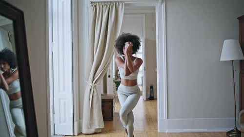 Woman Doing Yoga Pose Balancing in Bright Home