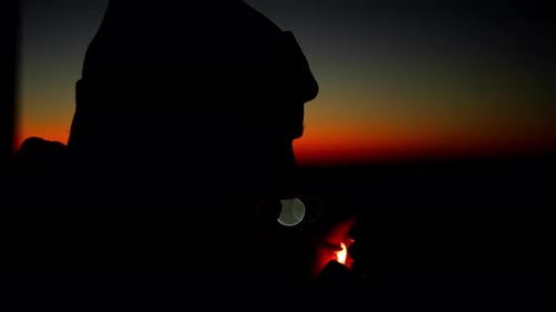 Slow Motion Video of a Man Lighting a Cigarette at Sunset