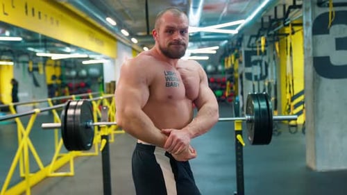Muscular Man Posing at the Gym