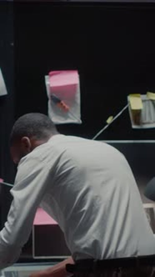 Investigator Analyzes Crime Board in Workplace