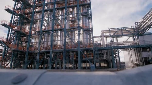 Wide shot of a grey modern newly built industry building. Camera dolly pans from right to left. The