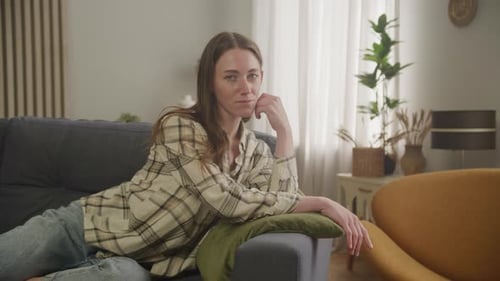Woman Reclining Comfortably on Couch at Home