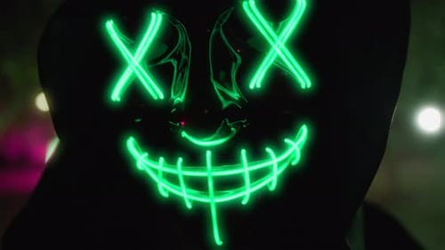 Figure Wearing Mask With Glowing Green Lines