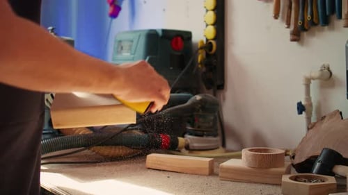 Woodworking Specialist Using Sandpaper to Do Manual Sanding on Lumber Close Up