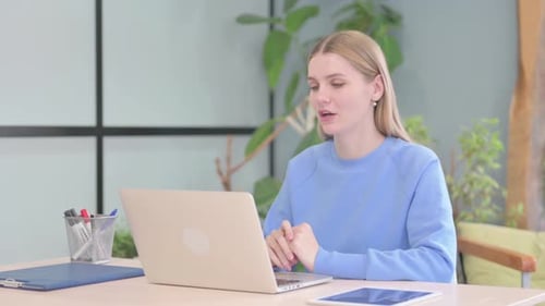 Young Woman Video Calling on Laptop From Home