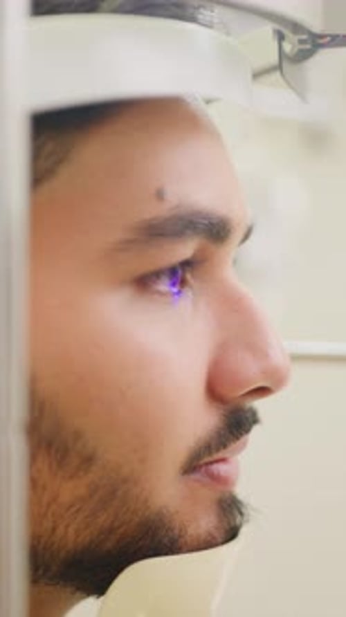 Man, optometrist and eye exam with machine for vision test, sight or scan in optometry