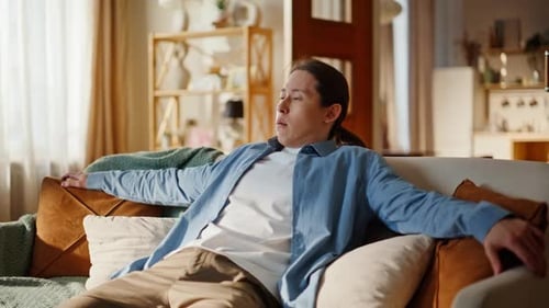Asian Man Taking Sit Falling Sofa at Home Closeup Exhausted Guy Having Rest