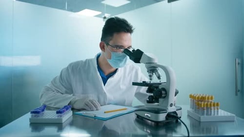 Scientist Analyzing Samples With Microscope in a Lab