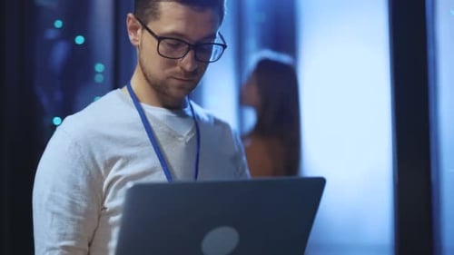 Man Working in Data Center with Laptop