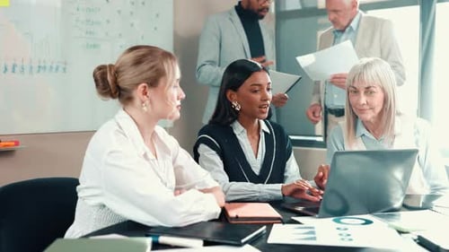 Laptop, meeting and teamwork with business people in office for data chart, report and discussion