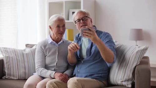 Senior Couple Taking a Selfie on Couch at Home
