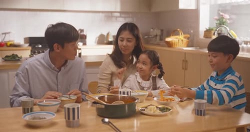 Happy Family Enjoying Meal Together in Bright Kitchen