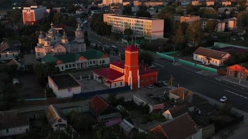 Aerial View Fire Department of a Stunning Urban Landscape with Churches and a Striking Red Tower at